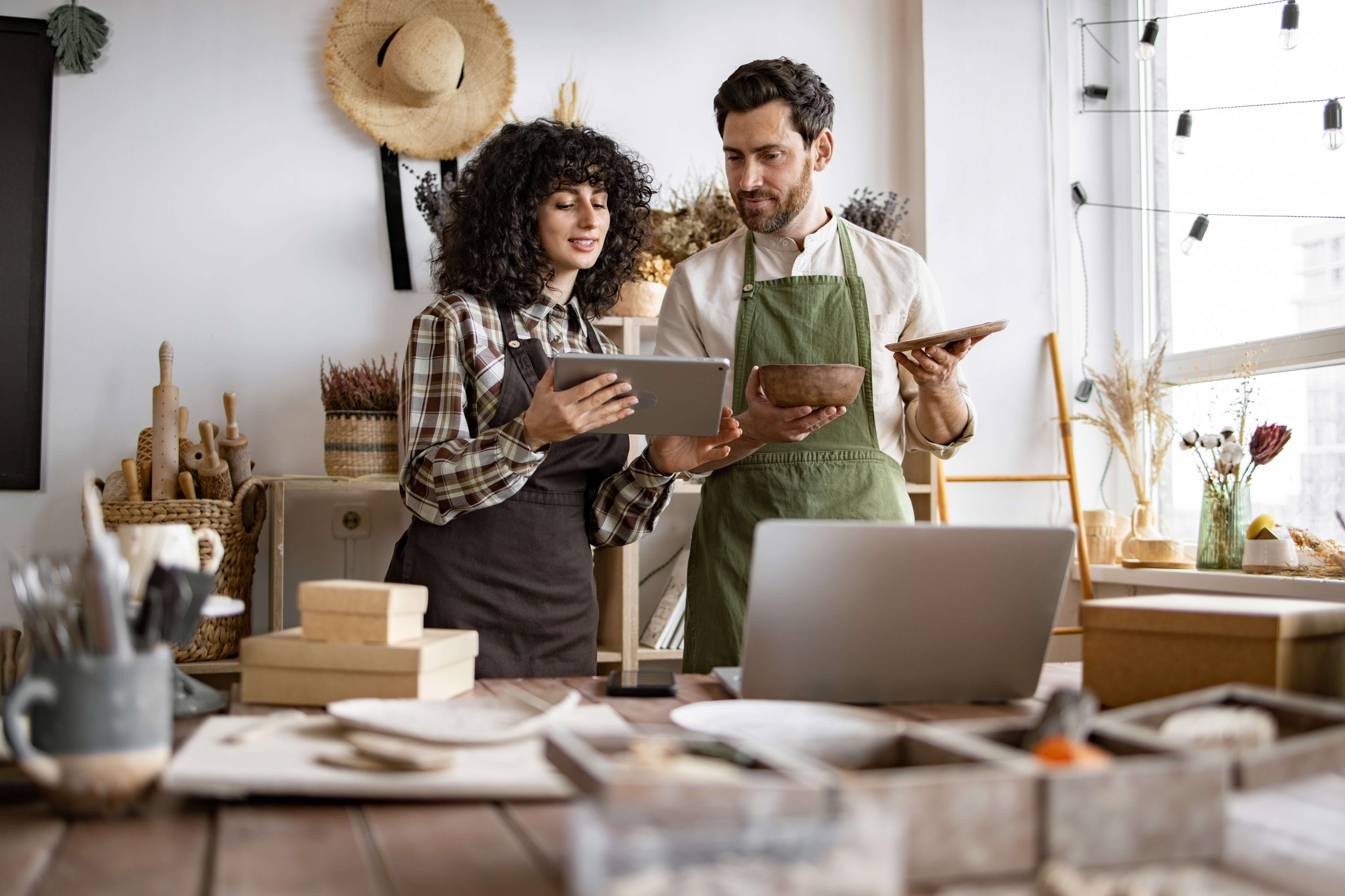 Two business owners reviewing plans in their workshop